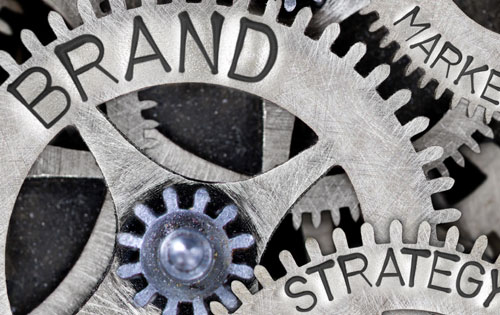 Brand-Strategy Gears and cogs with "Brand" and "Strategy" engraved into them.