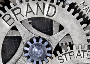 Gears and cogs with "Brand" and "Strategy" engraved into them.
