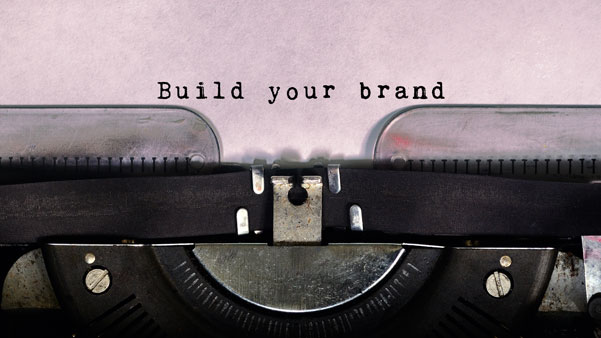about-magic-flight-brand Close-up of typewriter page with "Build your brand" inked into the paper.